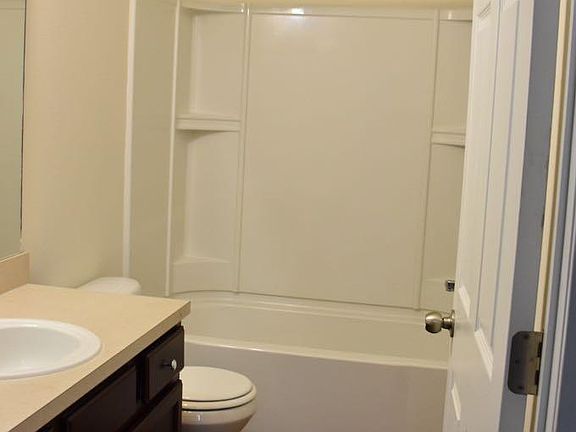 Spacious Master bathroom with linens closet behind the door!