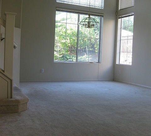 Bright and spacious living room and dining with vaulted ceiling.