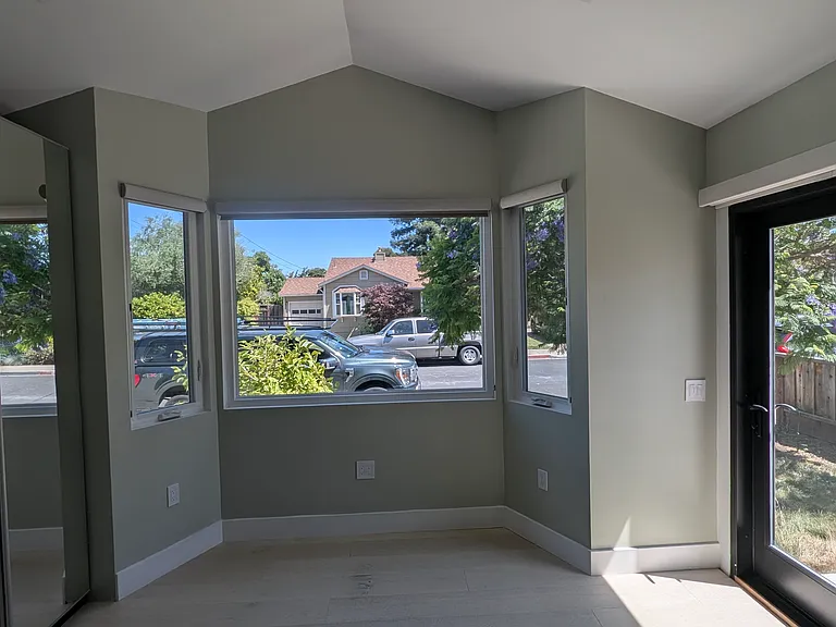 The panoramic windows in the alcove give you a full view of the property and the showy jacaranda and magnolia trees.