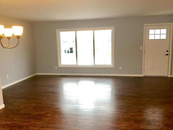 Spacious Living Room for the family with new laminate wood flooring - you'll love the new windows and natural daylight in the home.