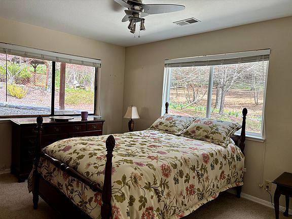 Primary bedroom, plenty of light, closet, built-in shelving and ceiling fan