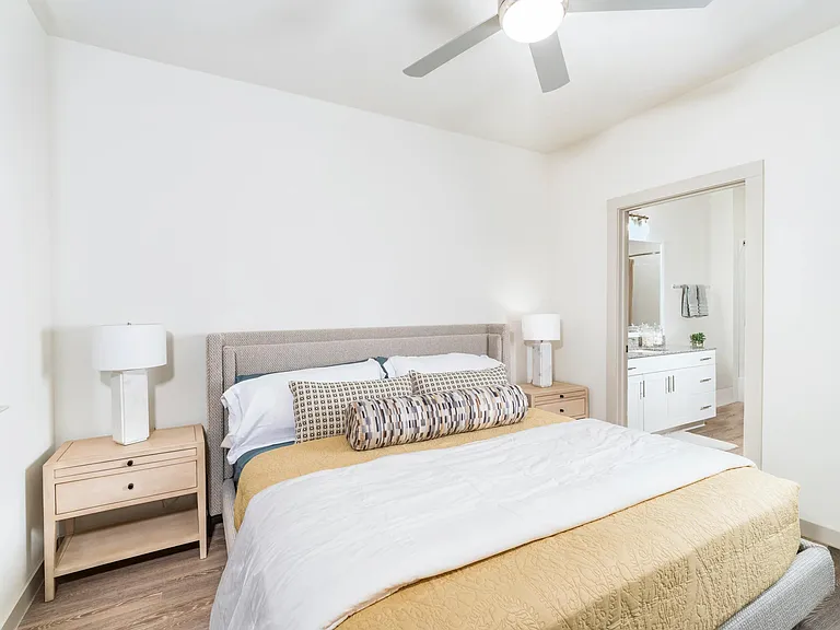 Granite countertops and sleek finishes create a refined bathroom retreat at Beckett West Fork in Conroe.