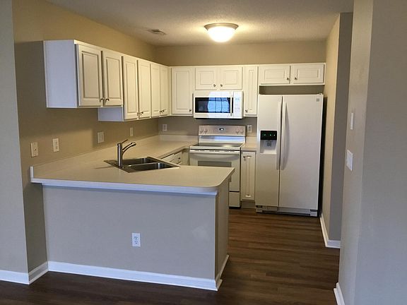 Kitchen opens to living room and dining room.