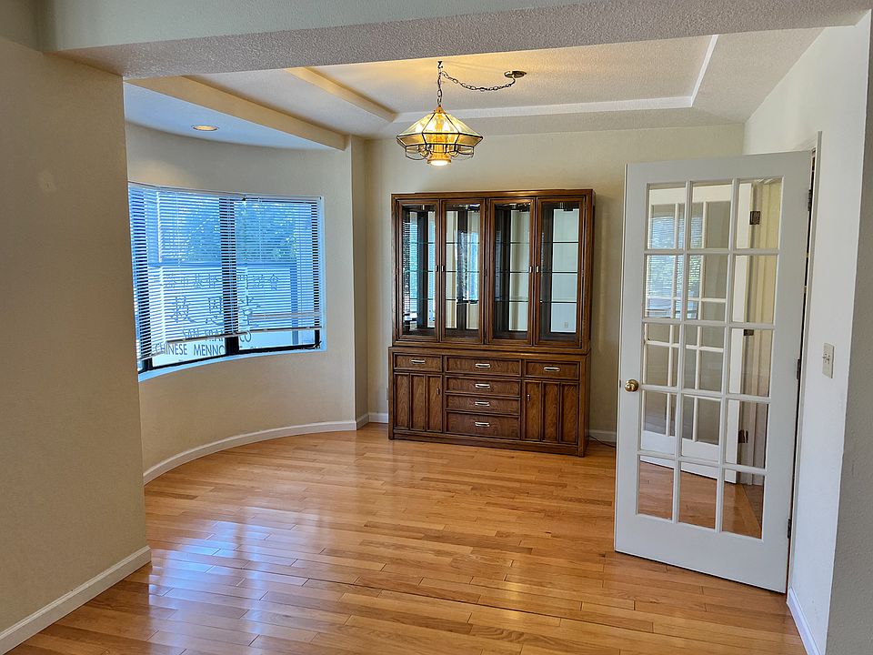 Bright dining room with cabinet to store your dishes and glasses and silverware.