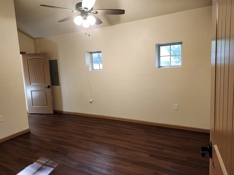 View of bedroom coming in through the door from the living room.