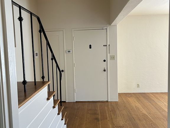 Front door and stairway leading to upstairs bedrooms