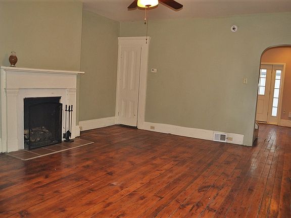 Large living room with decorative fireplace and two large wi