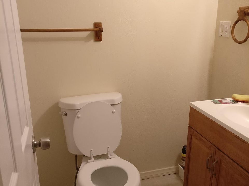Bathroom with oak vanity and newly reglazed bathtub