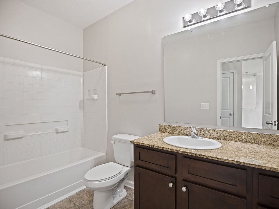 A white toilet sits next to a sink in a bathroom.