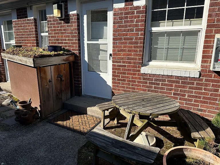 Exclusive of back patio area; Includes: Bike locker with living roof; pots ready for container gardening; cedar picnic table