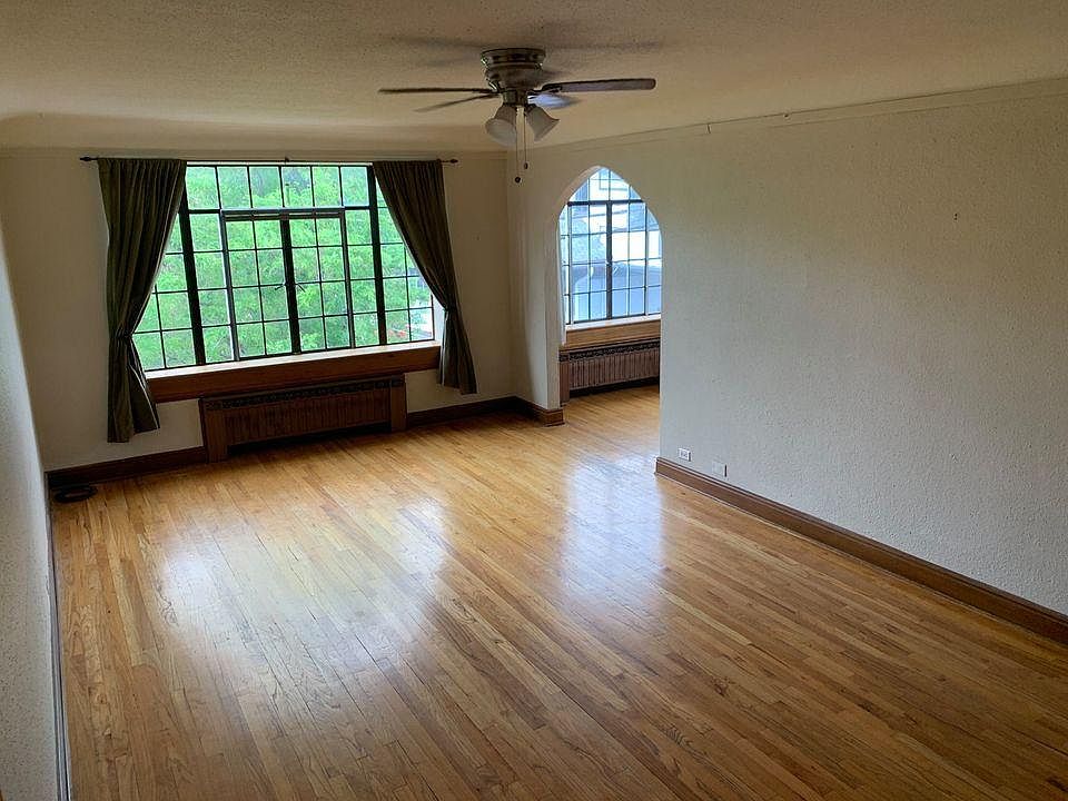 Large living room with picture windows facing north.