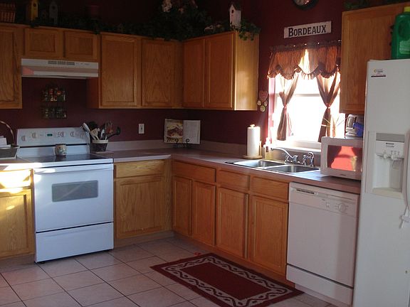 Kitchen with tile floors and oak cabinets