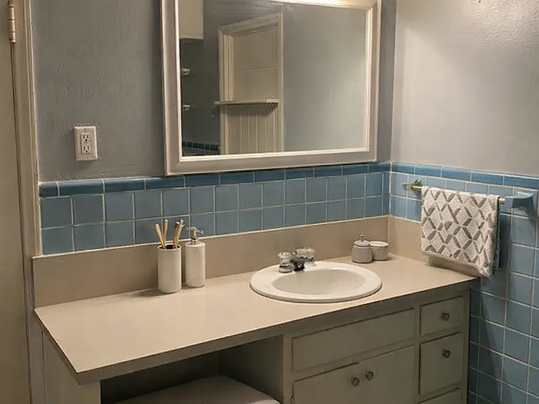 Bathroom has vanity area with space for a bench