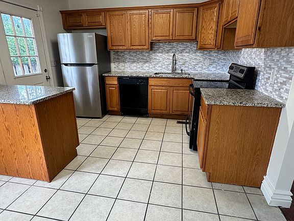 Tile floor. Back door opens to fenced patio