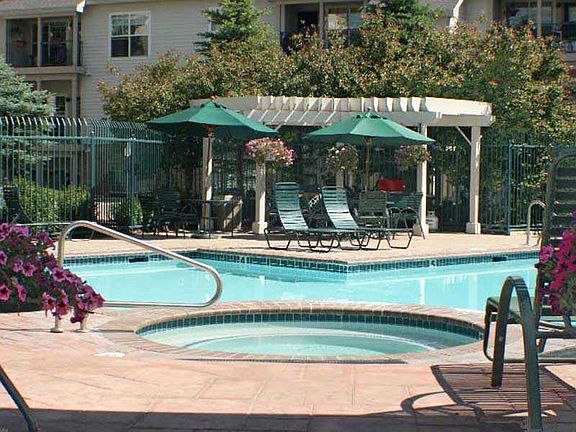 Swimming pool, sunbathing lounges, hot tub. In background is the Club House and CCC Office building.