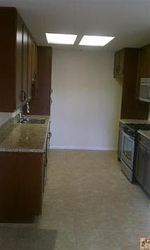 Remodeled Kitchen with tile flooring, stainless steel appliances, Granite Counter tops, and new cabinets.