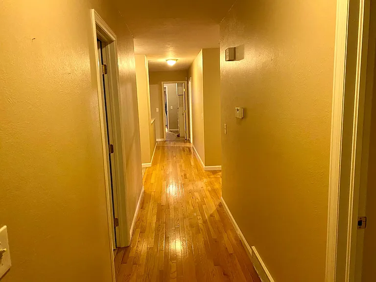 Long hallway view from bedroom area.