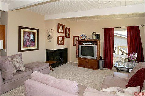 Living room with gas log fireplace and great views.