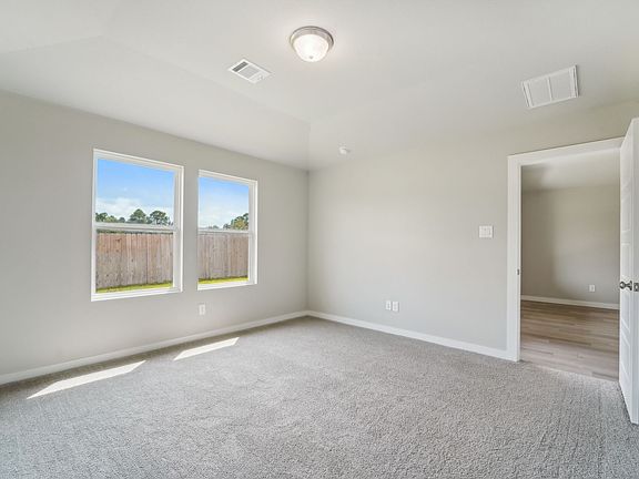 The bedroom in a home in Pine Lake Cove of Montgomery, TX.