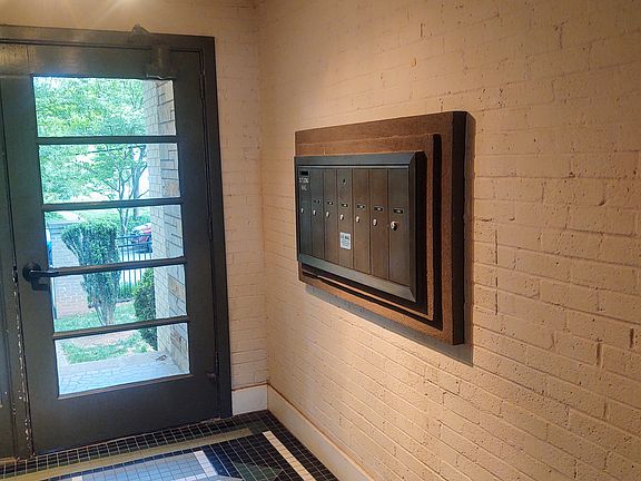 Hallway leading to the unit with locked mail boxes.