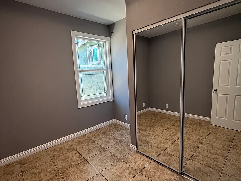 First bedroom with all new lighting fixture, new sliding mirror doors, and fresh paint