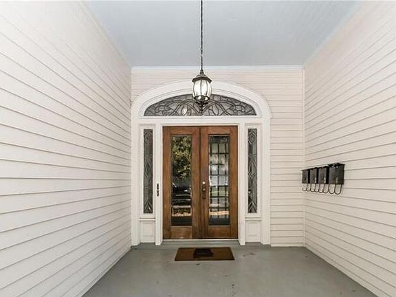Formal front entrance to inside staircase. Features original leaded glass door.