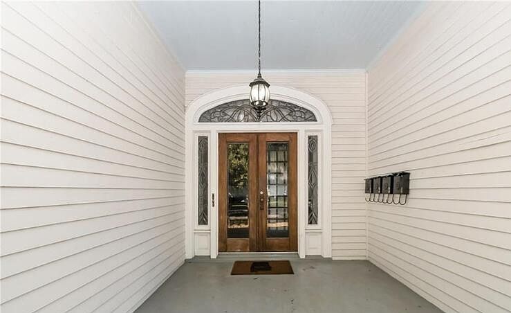 Formal front entrance to inside staircase. Features original leaded glass door.