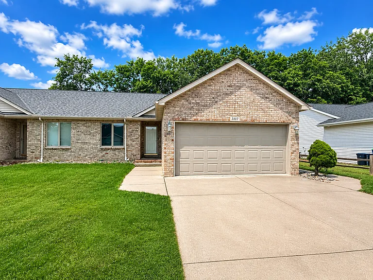 Spacious attatched garage with people door to side yard
