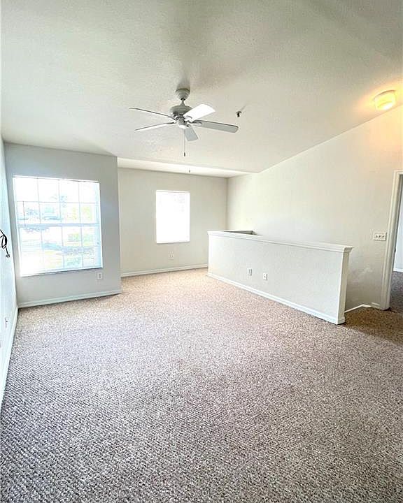 Living room view with extra space for home office.