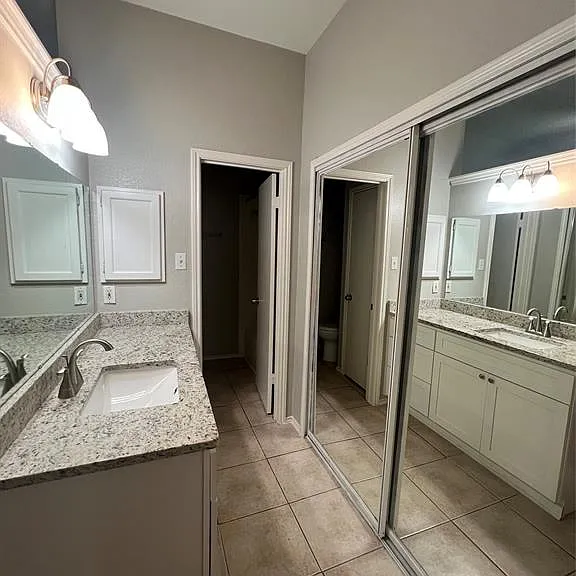 vanity with undermount sinks and light-toned countertops