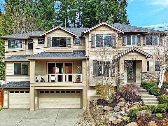 The first photo of the front of house shows it in full bloom during the summer months, this photo is current & shows how it is all about to bloom.