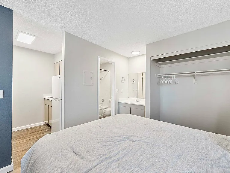 Experience the comfort of this modern bedroom, perfectly blending functionality and style.