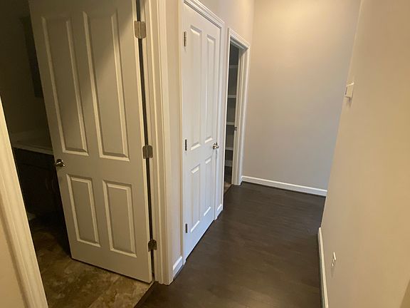 Hallway from garage passing laundry room, storage closet and pantry