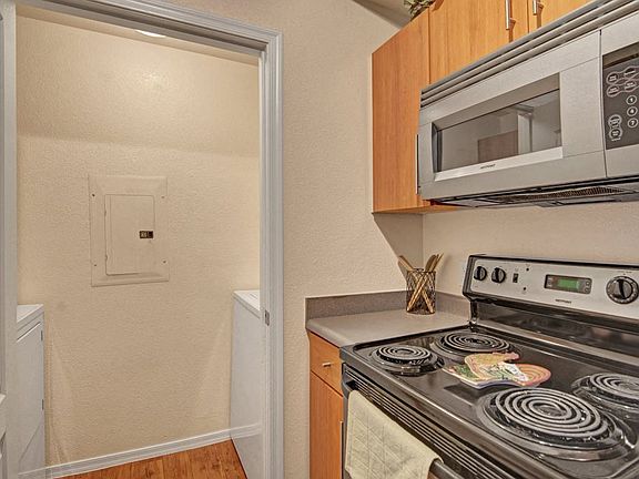 Acclaim Apartments- kitchen with a stainless-steel stove and microwave
