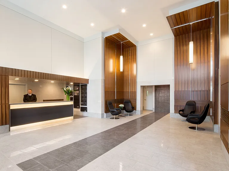 A welcoming lobby with doorman service, combining convenience and charm