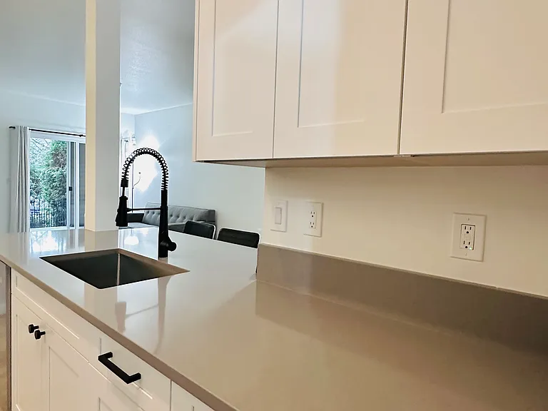 Brandnew kitchen cabinets, undermount sink, and quartz countertop.