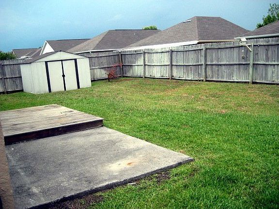 Wood fenced yard great for the furry friends or kids to play