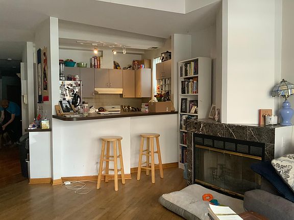 Open kitchen, living room and eating area. Stainless fridge and dishwasher. Great breakfast bar and fireplace. There is room for a dining table &/or office space too!