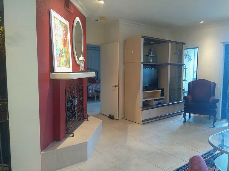 FIREPLACE IN LIVING ROOM WITH TILED FLOORS AND CARPETING BEDROOMS...NOTE ALL ROOMS REPAINTED IN NEUTRAL TONES
