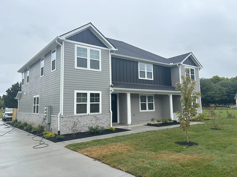 Left side with wide driveway to rear parking.