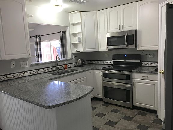 Kitchen with granite countertops, stainless steel appliances