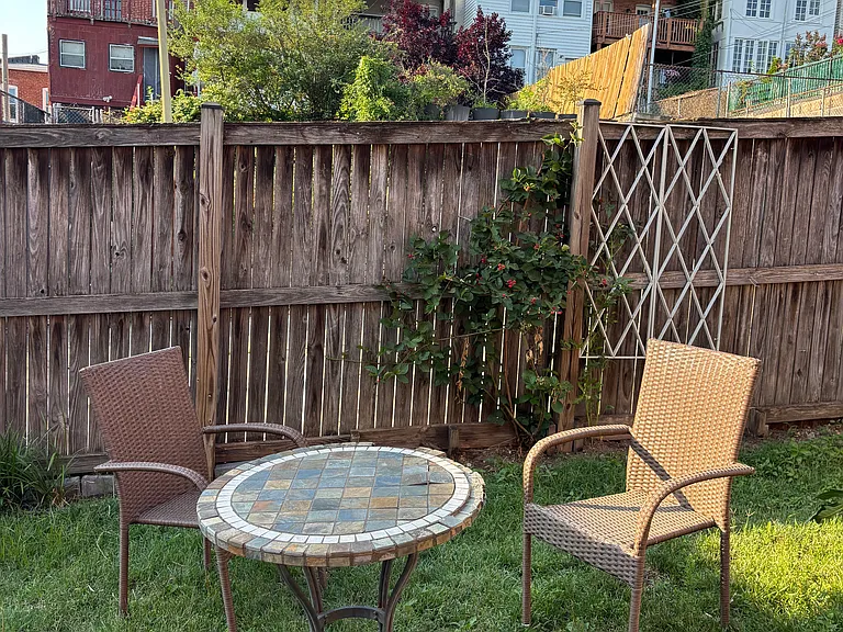 Shared backyard with patio table and chairs.