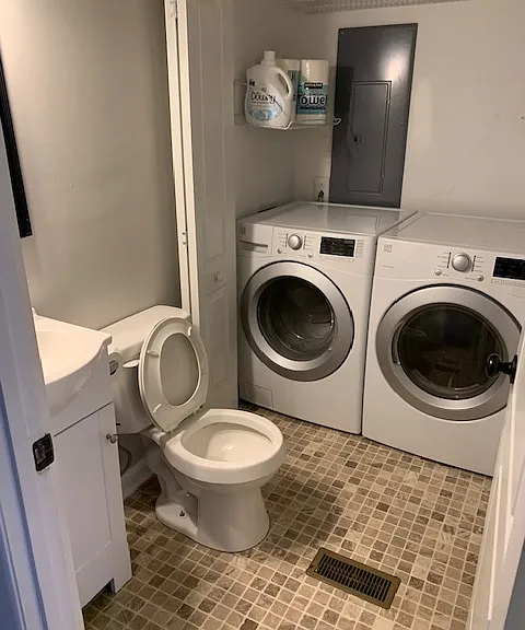 Half bath with washing machine and dryer.