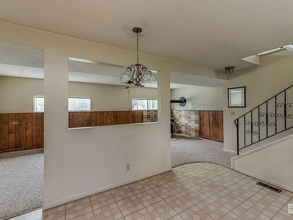 Kitchen looking into family room and stairs to main level