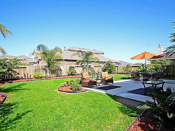 EXCELLENT OUTDOOR LIVING SPACE AND LUSH LANDSCAPING GIVE A TRPOICAL FEEL TO YOUR OWN BACK YARD