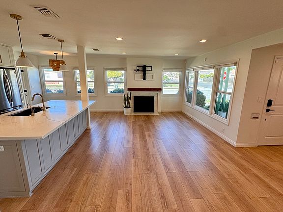 Living room with fireplace and retractable TV mantel mount included.