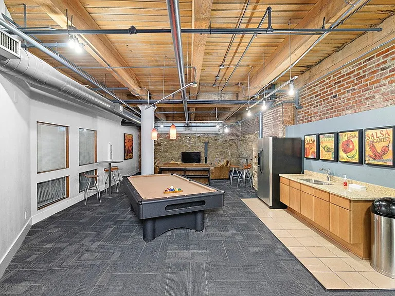 Club Room featuring pool table, TV, couches, fridge, microwave and sink.