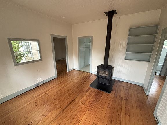 living room with wood stove heat. refinished fir original fir floors