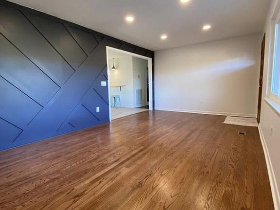 Designer accent wall and recessed lighting make a wonderful first impression