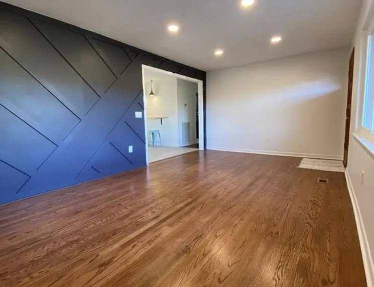 Designer accent wall and recessed lighting make a wonderful first impression